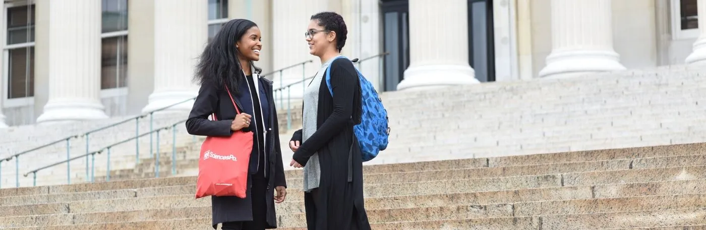Dual BA students walking on the steps of Low Library at Columbia